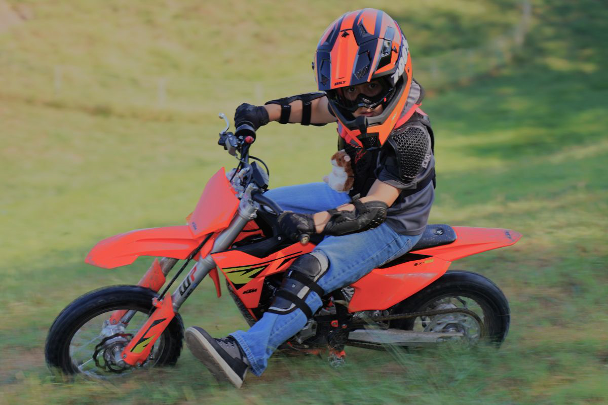 Eight-year-old riding a KTM SX-E 5 motorcycle