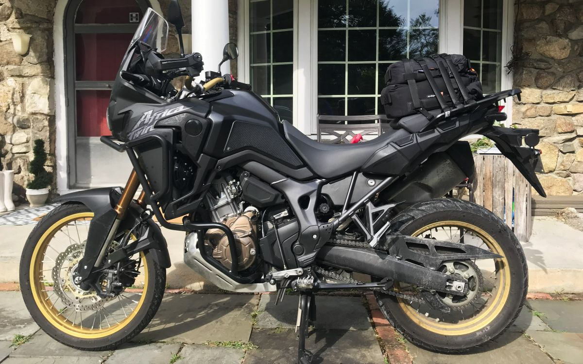 Honda Africa Twin motorcycle with Kriega bags and 3M reflective tape in the daytime